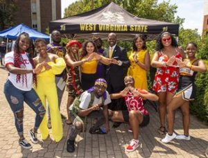 Photo of students outside at an event posing