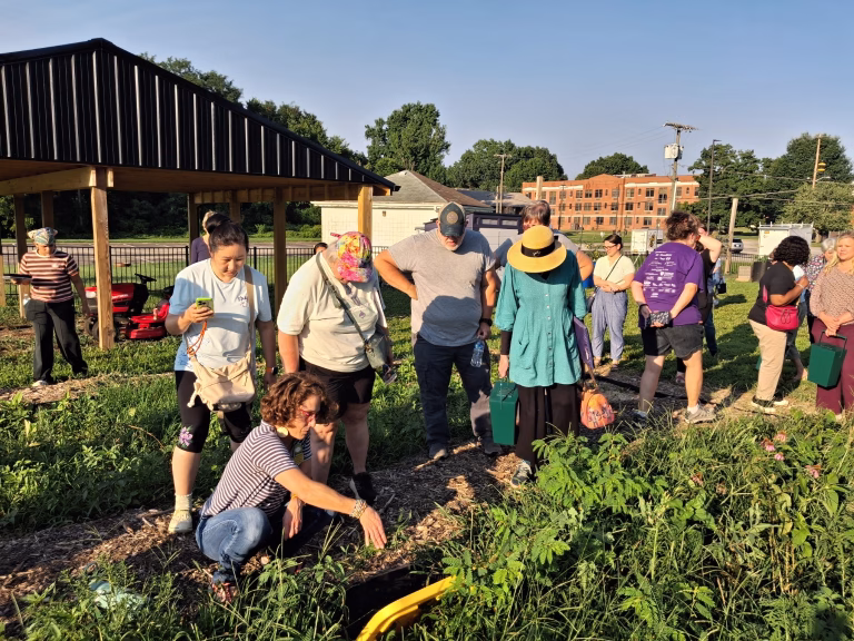 WVSUDemoSite1 West Virginia State University Extension Associate Liz Moss (bottom left) conducts a composting workshop with attendees at the University’s new onsite demonstration garden.